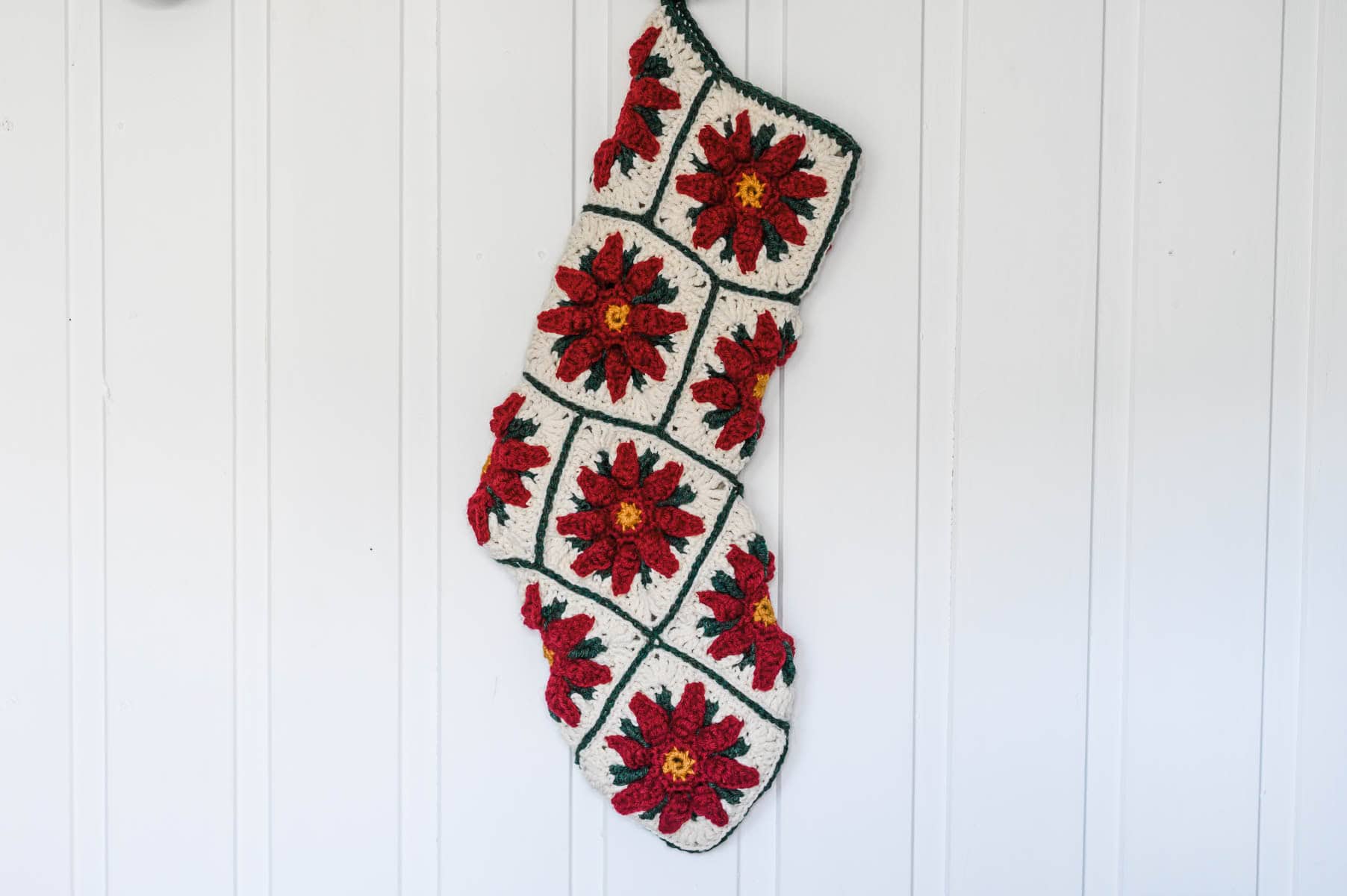 Poinsettia Granny Square Christmas Stocking with a white background