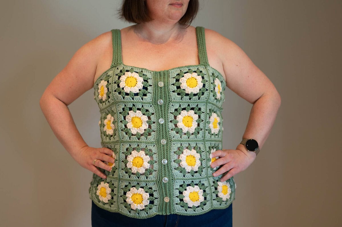 photo of a woman wearing a crocheted granny square tank top