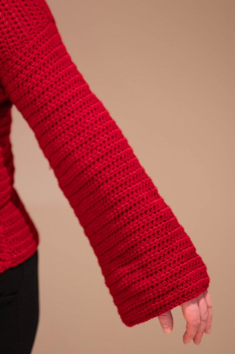 A dark red crochet bell sleeve made with Hobbii Kind Feather yarn.